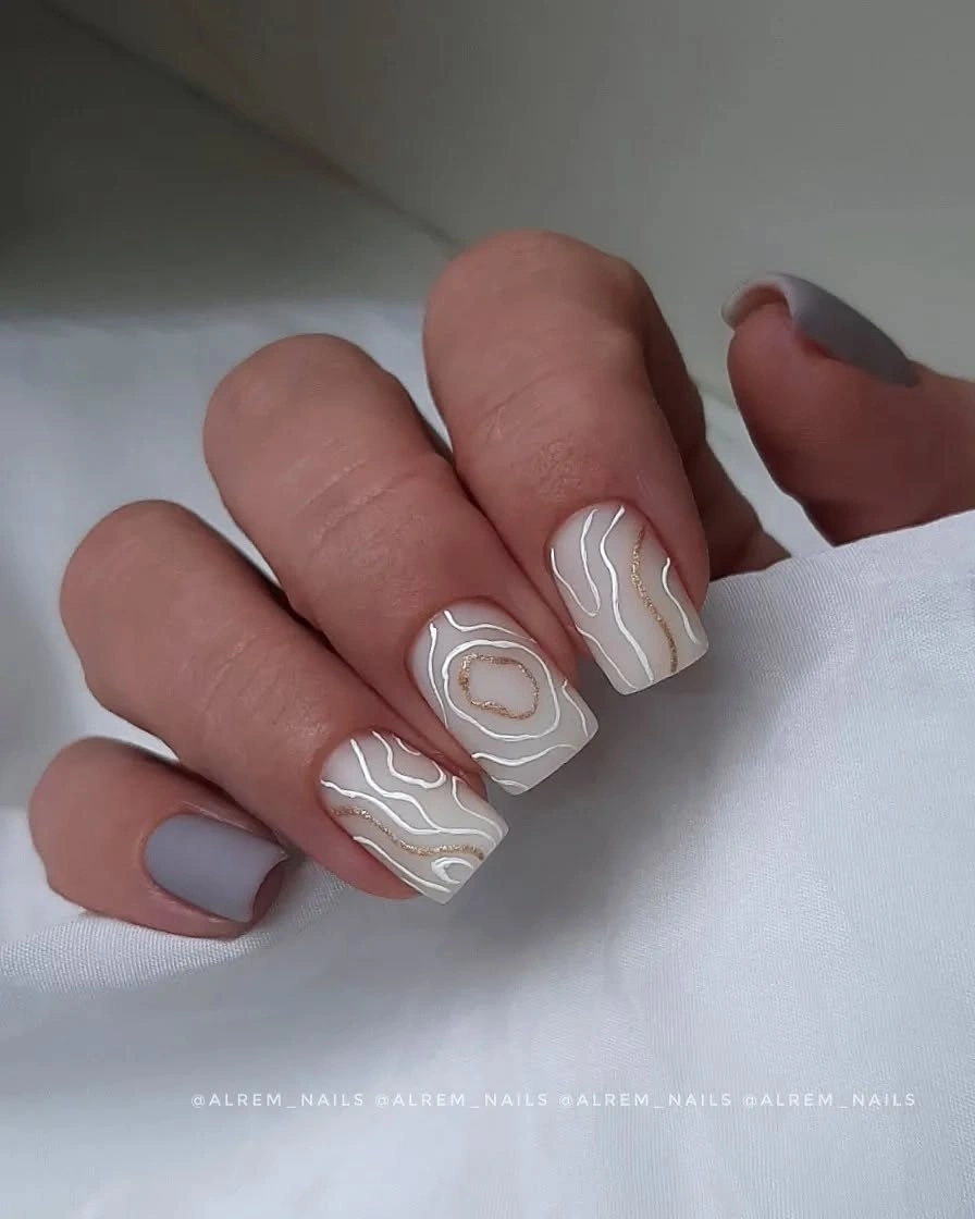 Short nude and gray nails with layered white contour line art