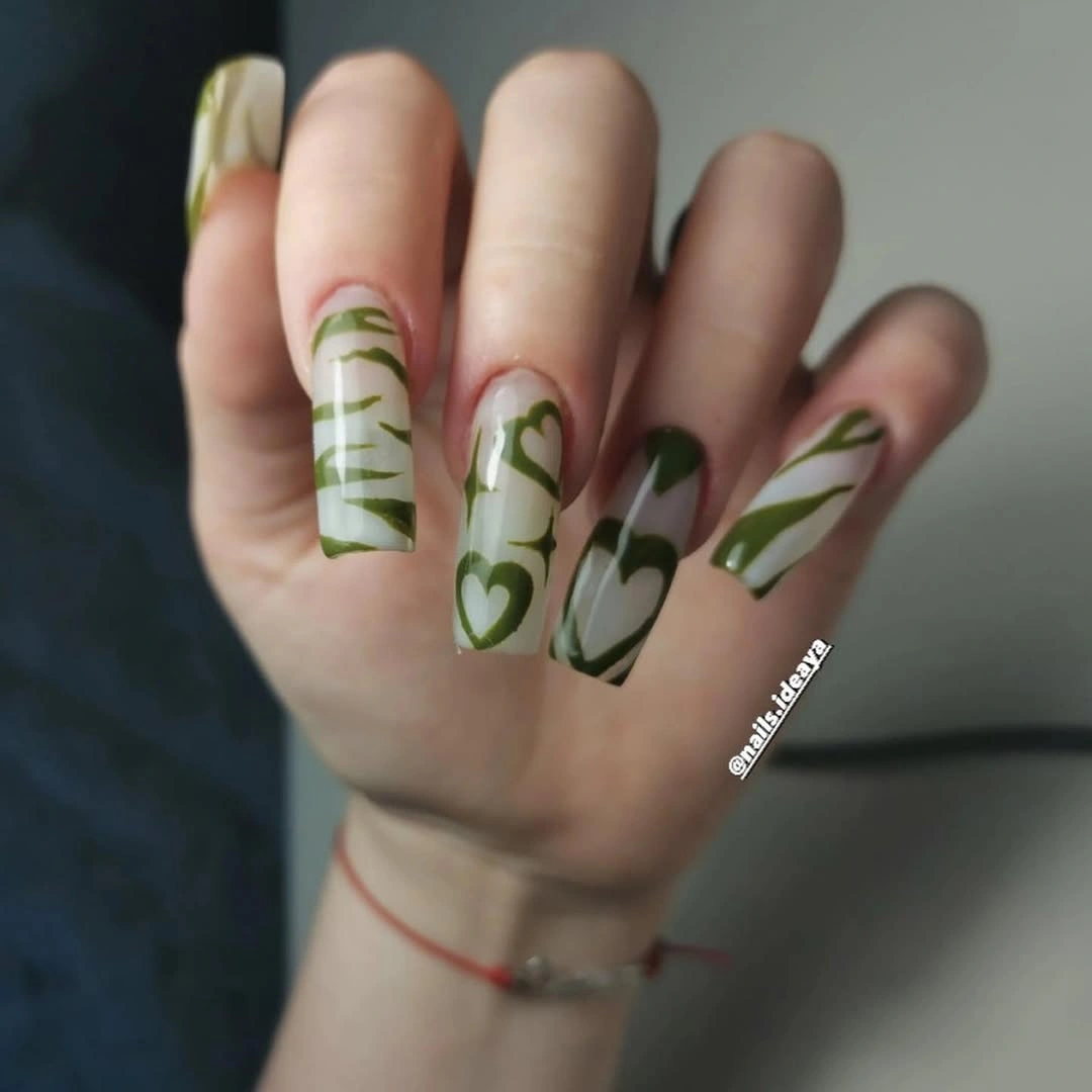 Long cream square nails with olive green abstract stripes blocks and heart shapes