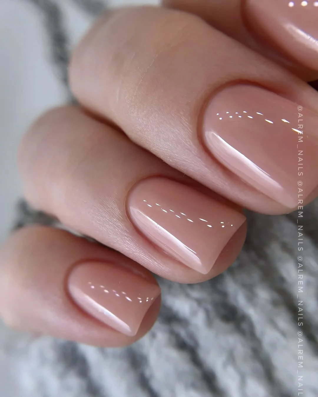 Short glossy nude pink square nails in one even solid color