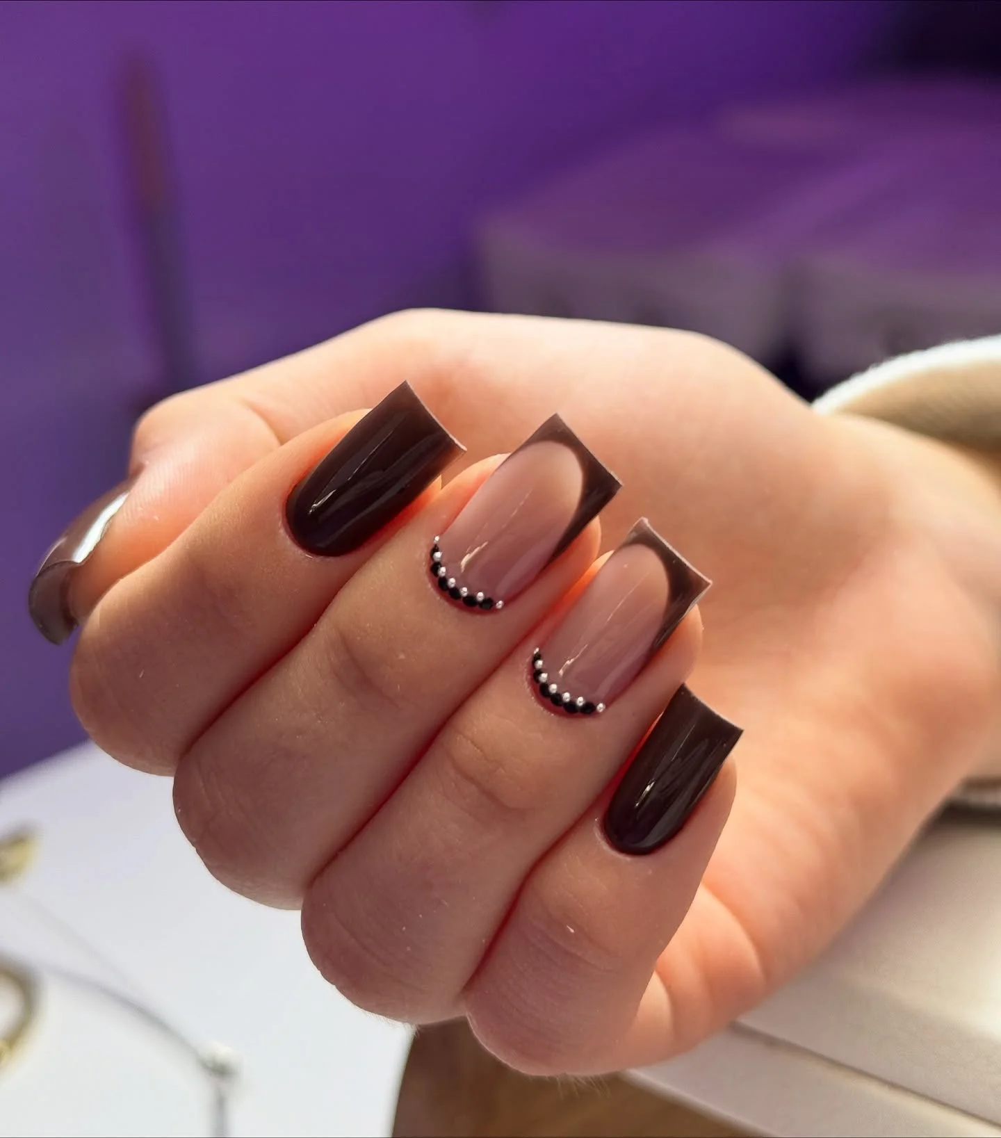 Medium square brown and nude nails with curved dotted border details