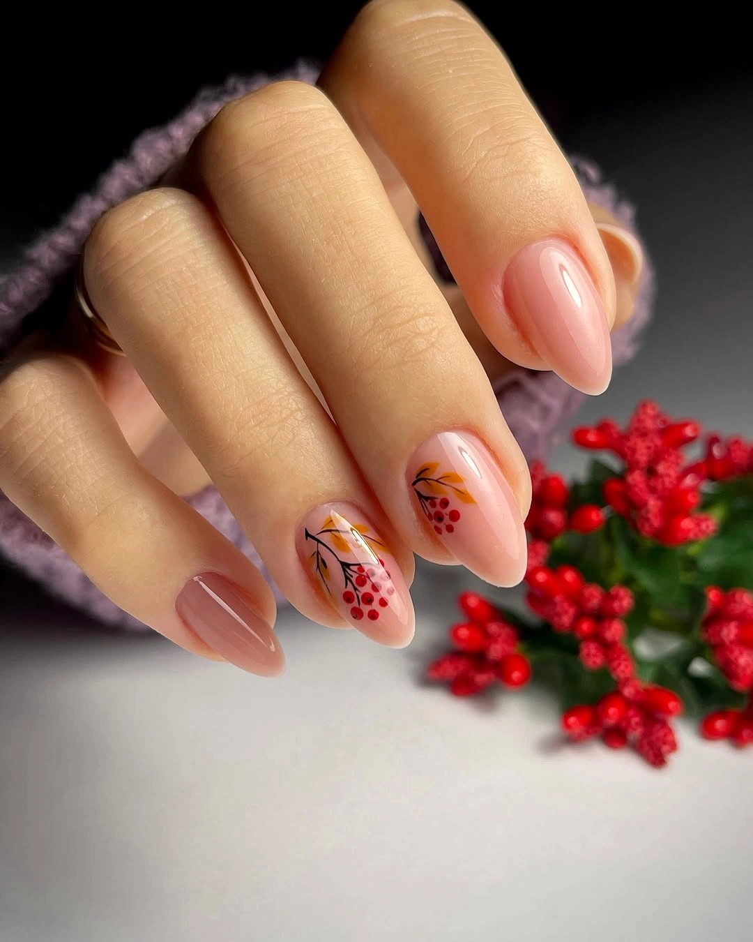 Peach nude almond nails with small rust botanical accents and dots