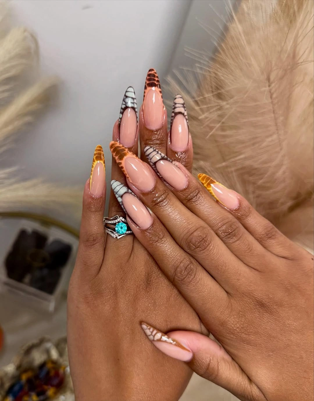 Very long stiletto fall nails with pale pink orange yellow and white stripes
