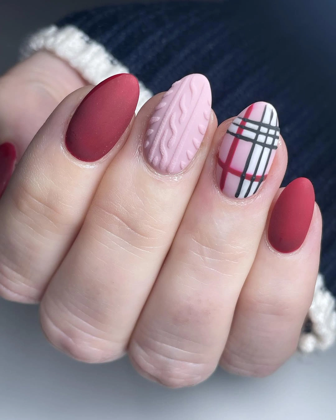 Short oval berry red nails with pink textured and plaid accent nails