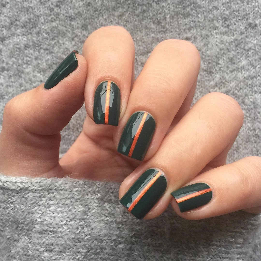 Short rounded-square deep green nails with orange and pale blue stripes