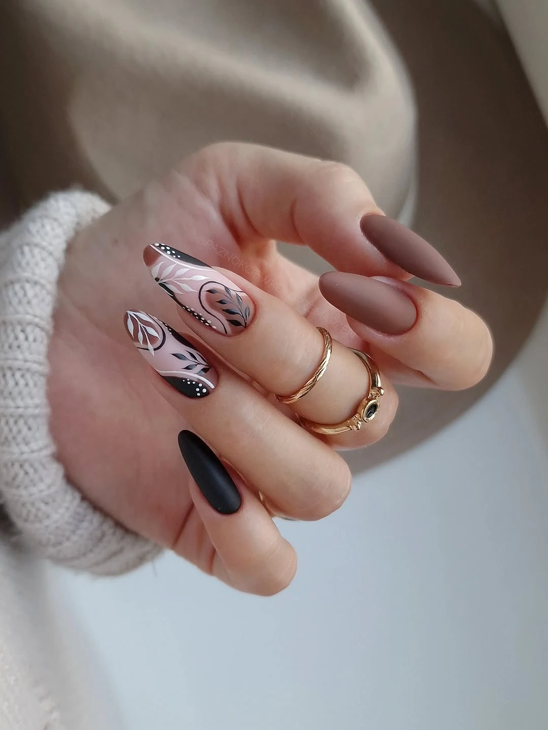 Long almond blush nails with curved line art and one dark accent nail