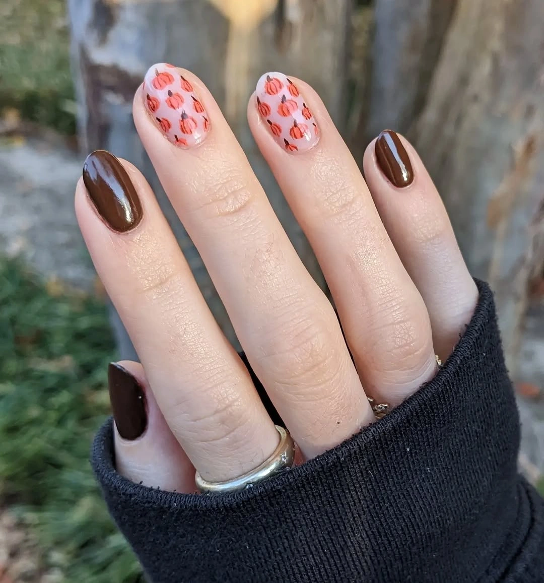 Short rounded chocolate brown nails with peach floral accent fingers