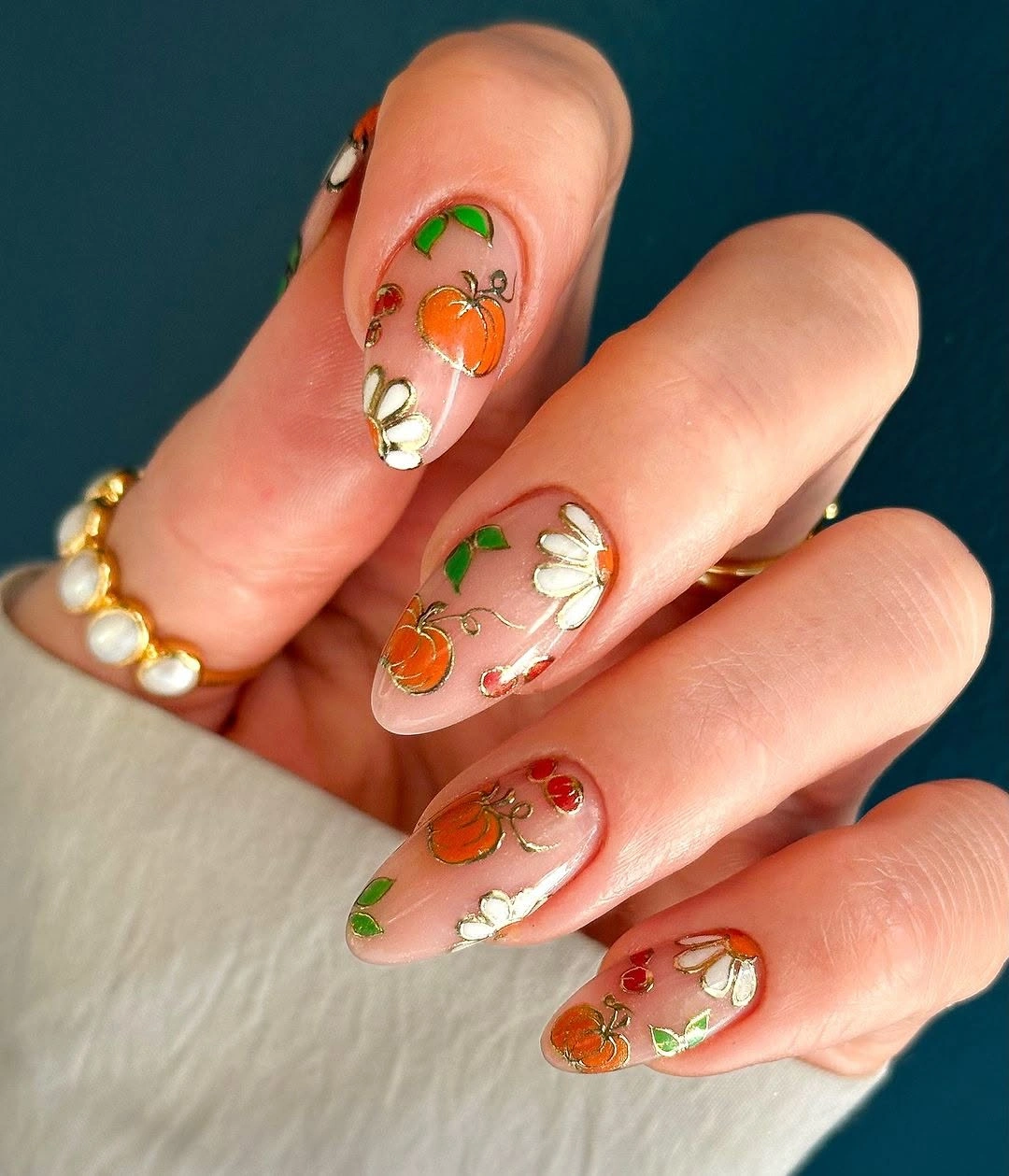 Long almond translucent fall nails with orange green and white seasonal accents