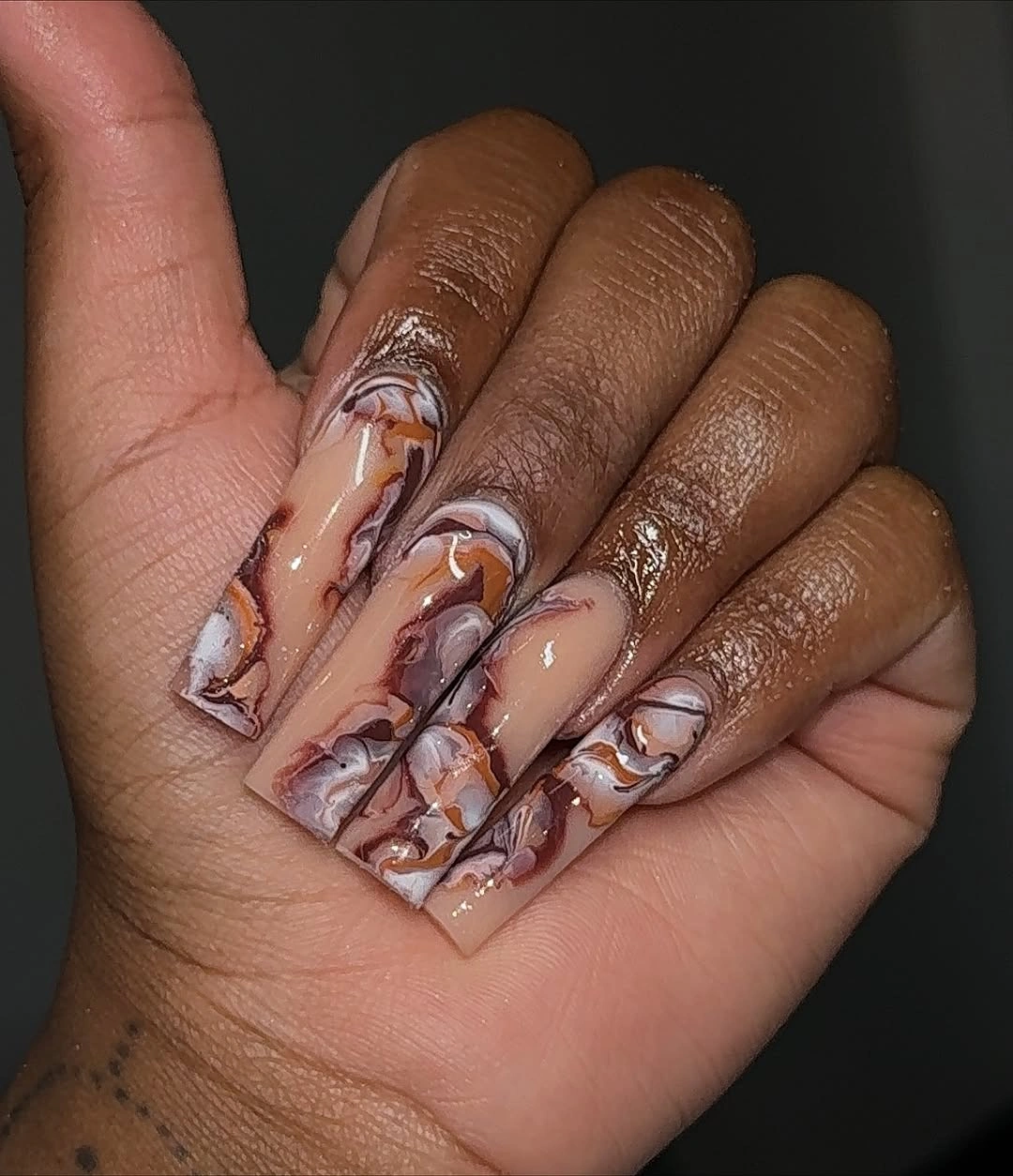 Long square nude nails with brown marbled reflective waves