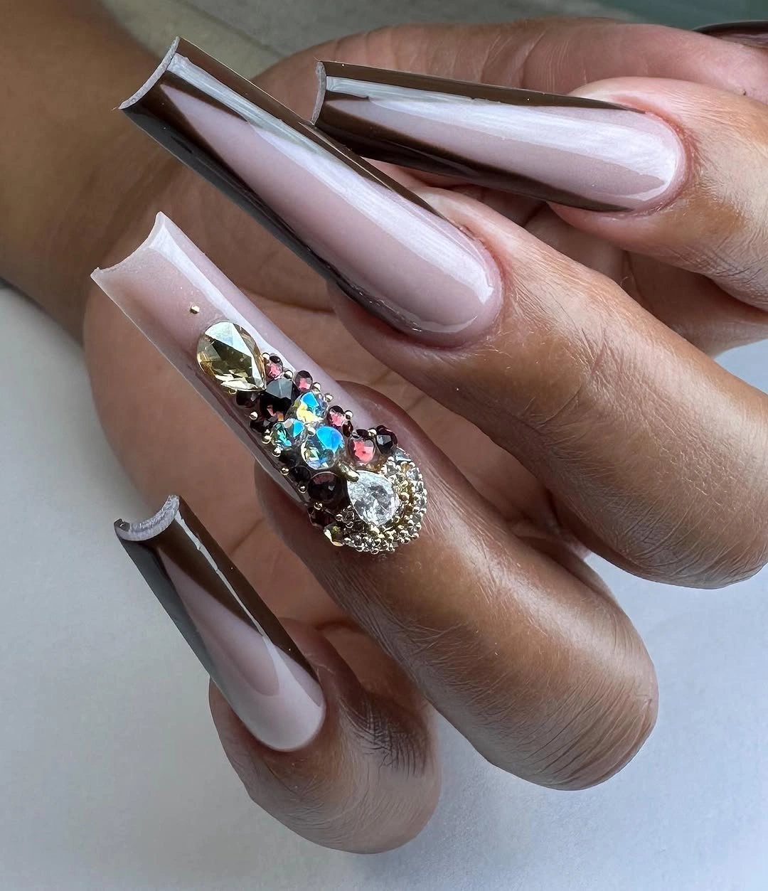 Long pale pink nails with one dense sparkling accent