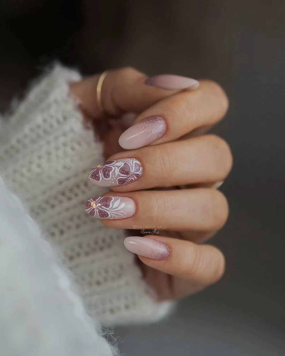 Medium almond nude nails with soft lilac floral accents