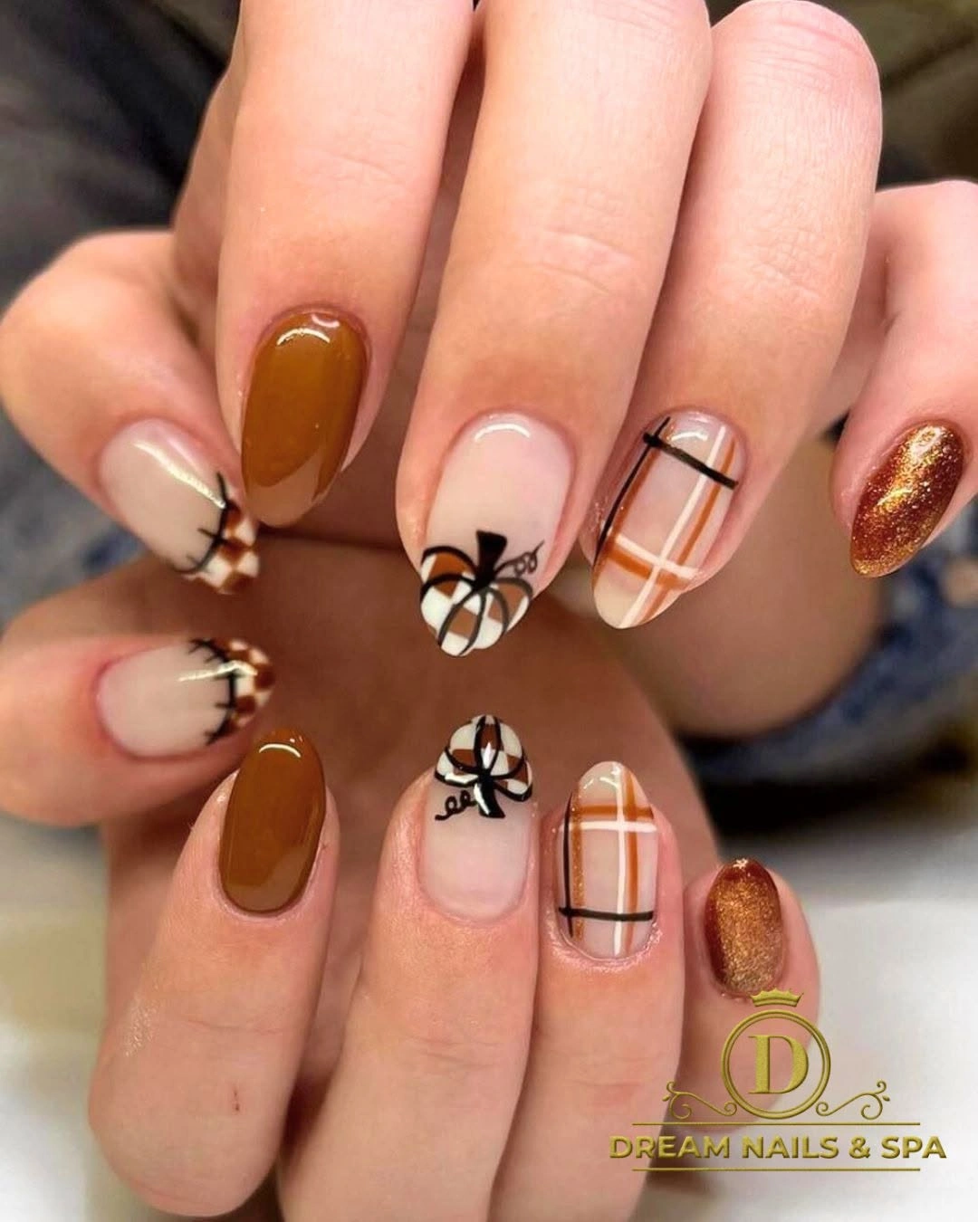 Medium almond amber nails with black white and gold details