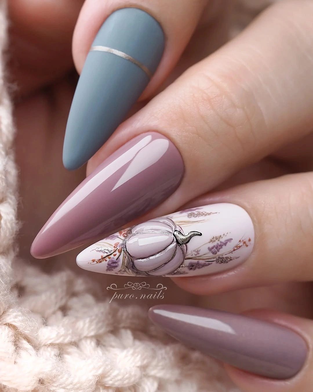 Cool-toned almond nails with a pumpkin and botanical line art