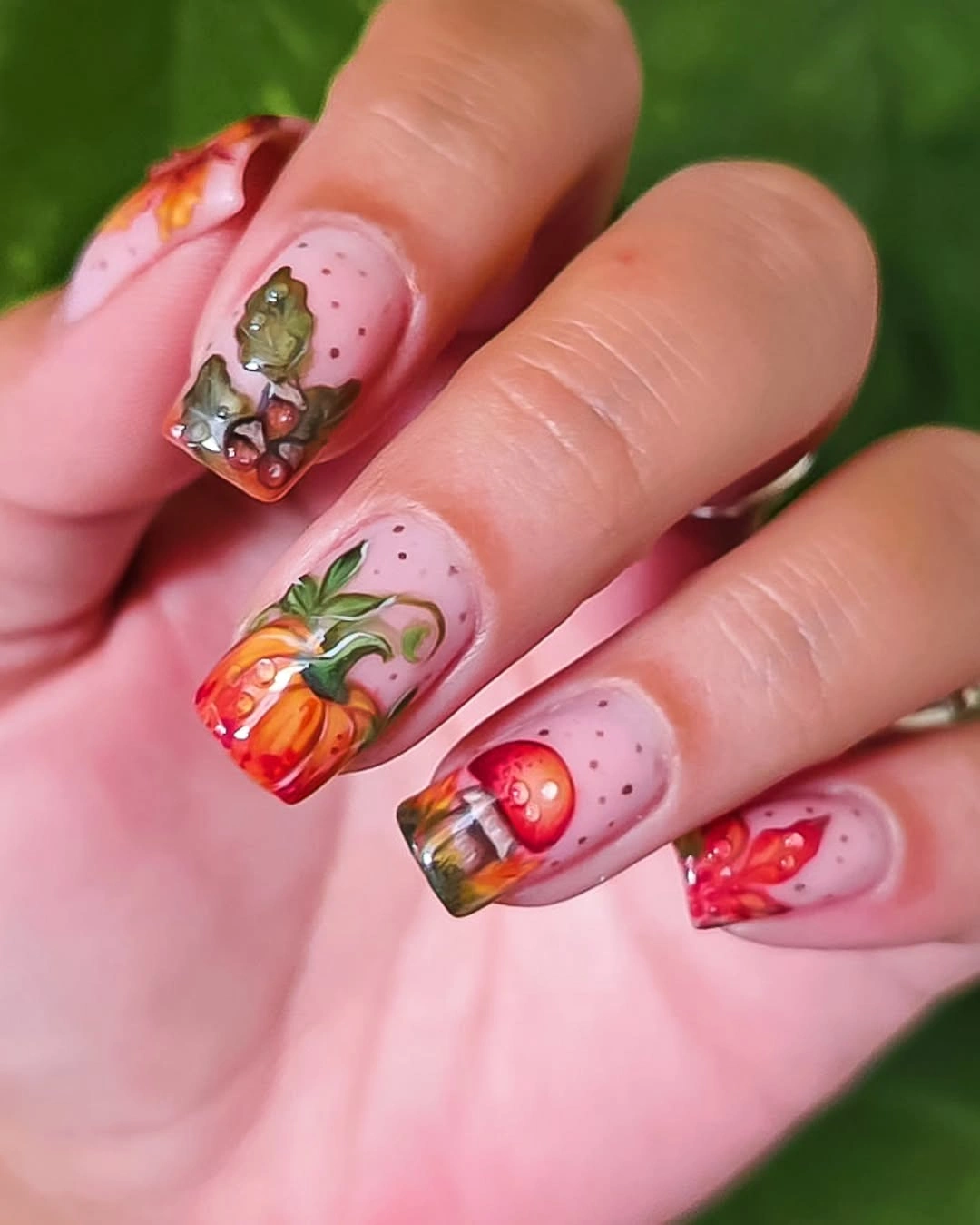 Short pink square nails with orange pumpkin and leafy accents