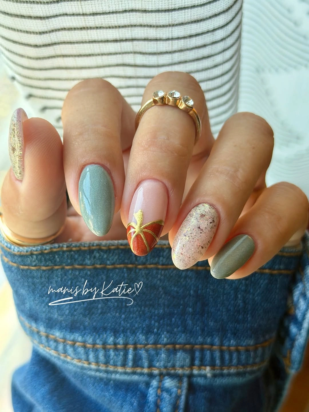 Muted pastel oval nails with a small pumpkin and leaf