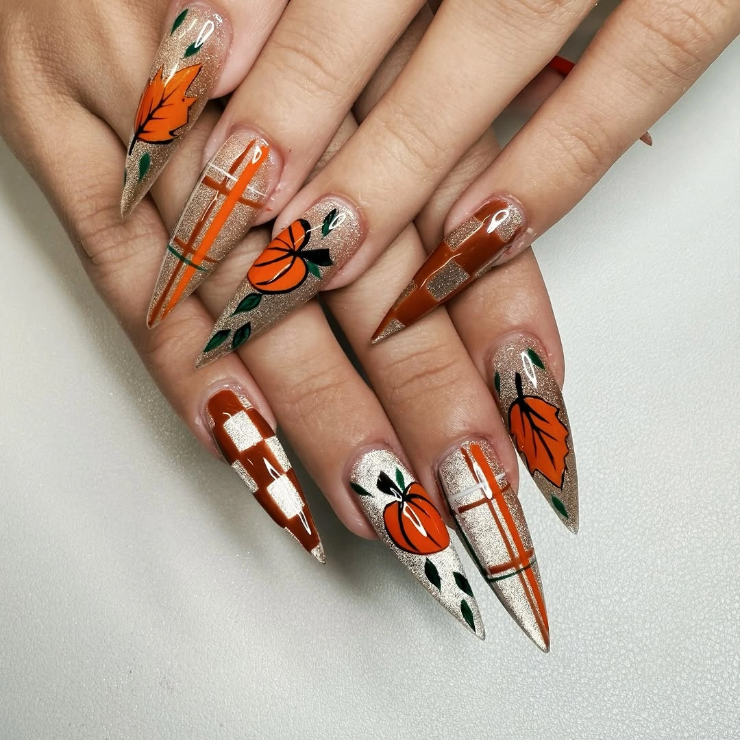 Long pointed nails with pumpkins, leaves, plaid, and clear space