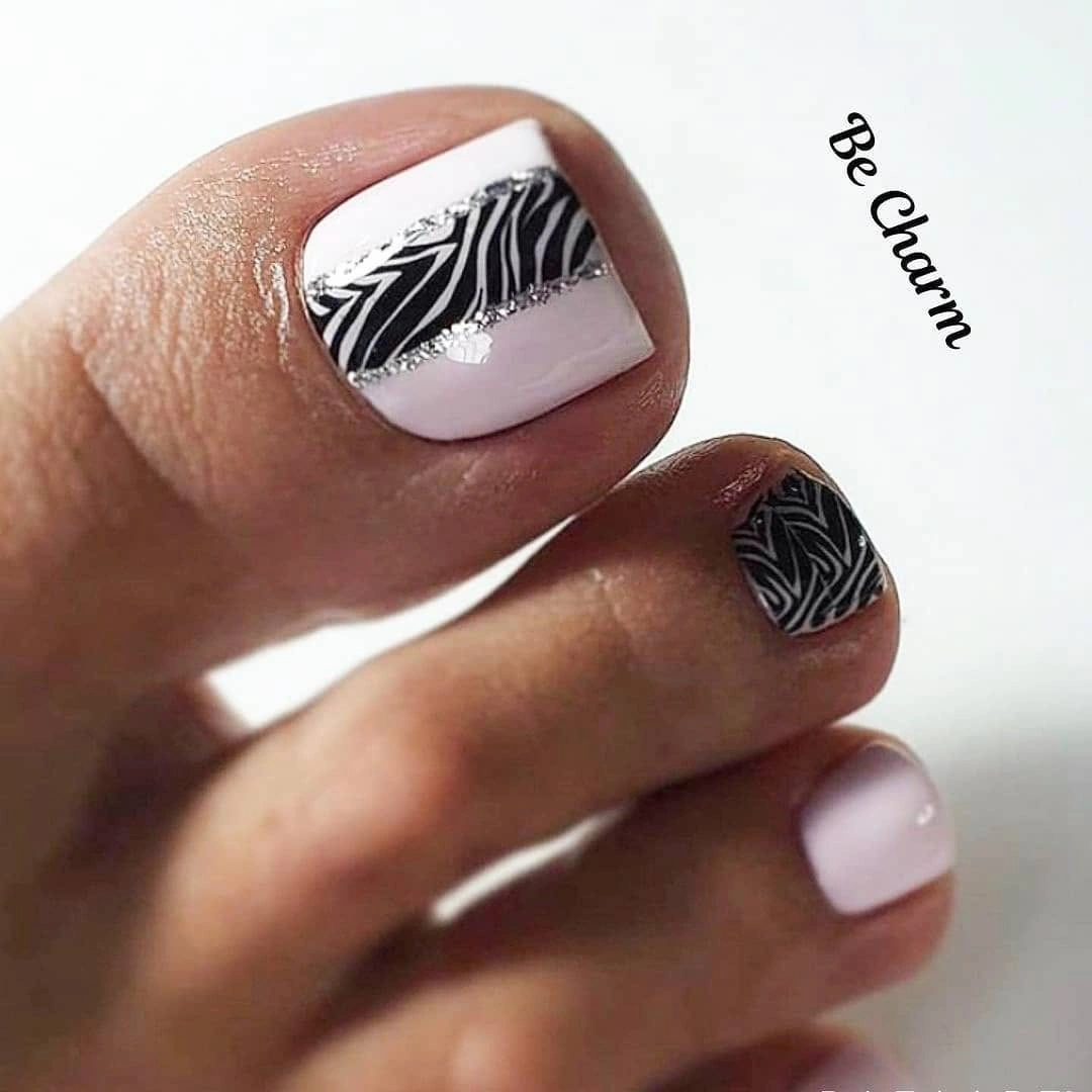 Pale pink pedicure with zebra band and silver lines