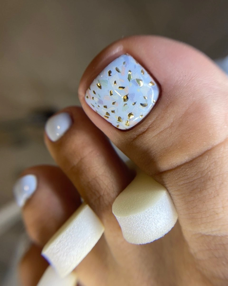 White terrazzo pedicure with gold flecks