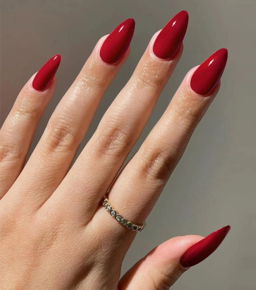 Deep red stiletto nails with smooth glossy finish