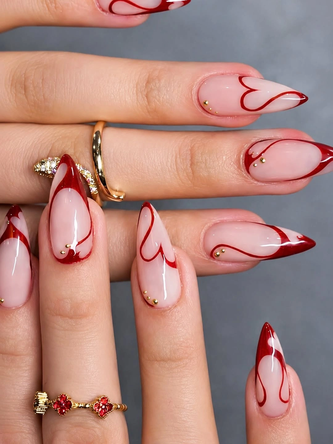 Red heart French tips on nude almond nails
