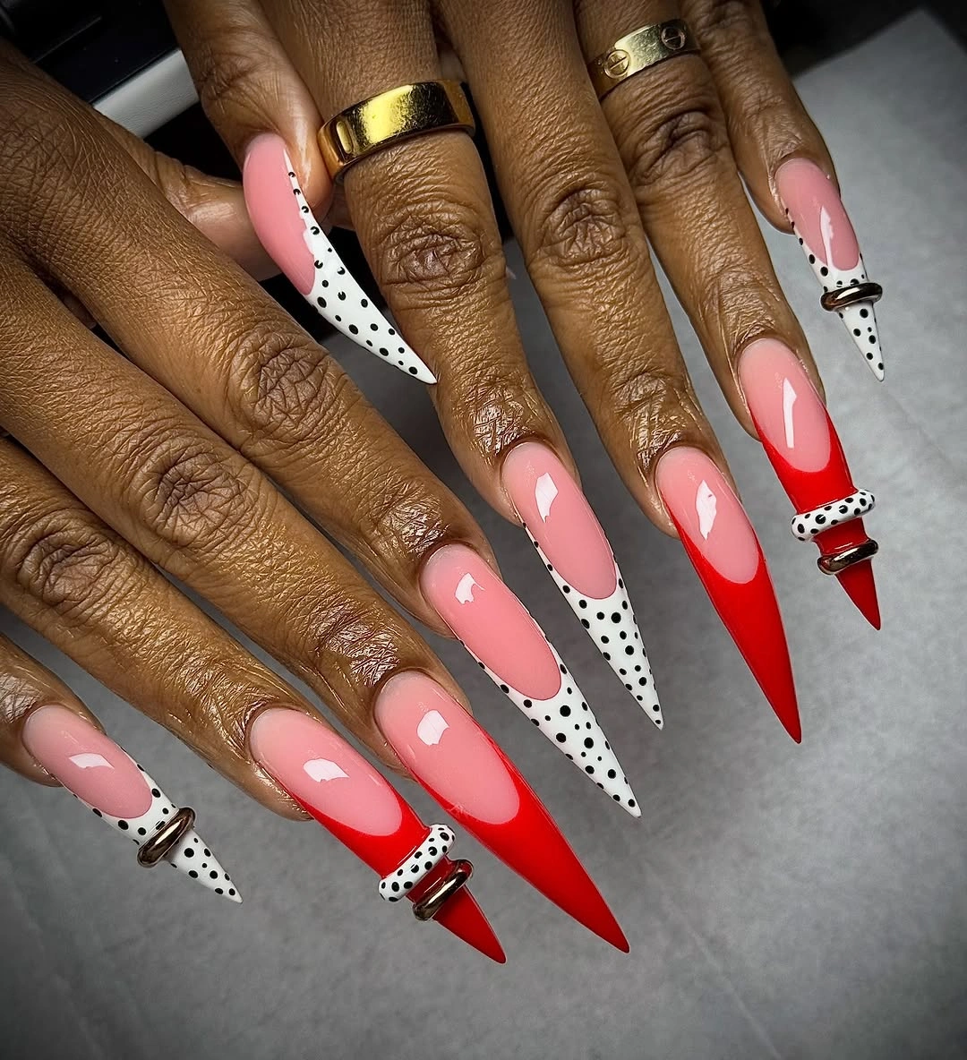 Extra long red stiletto nails with polka dot tips