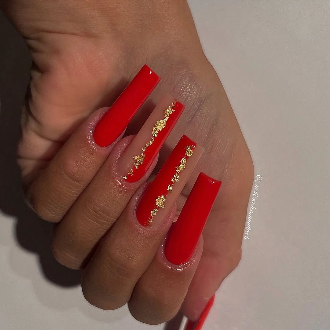 Long red square nails with gold foil accents