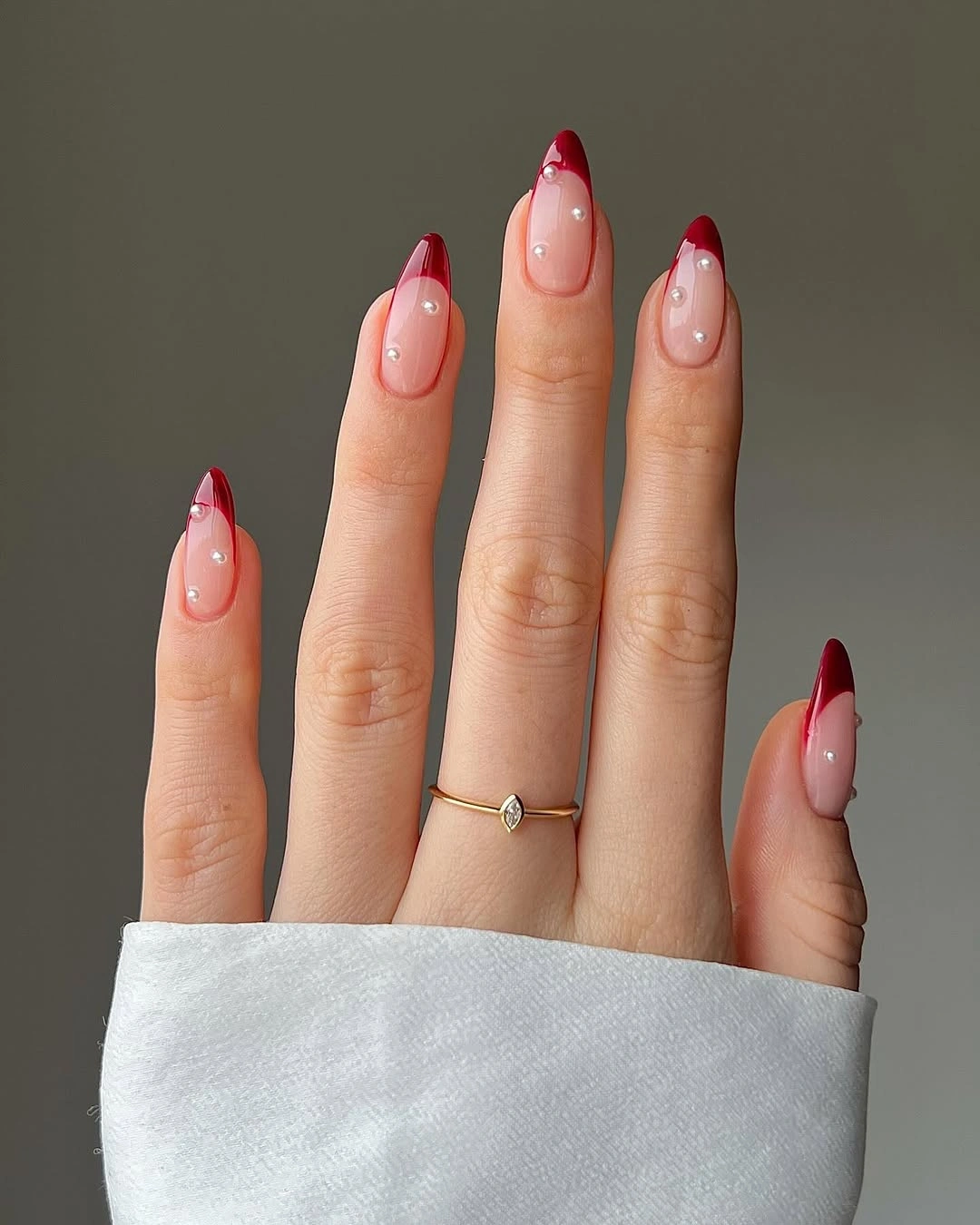 Red French almond nails with pearl dot details