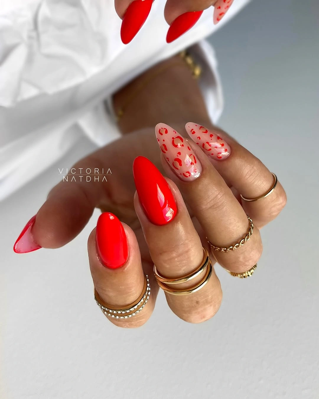 Red leopard accent nails with glossy almond tips
