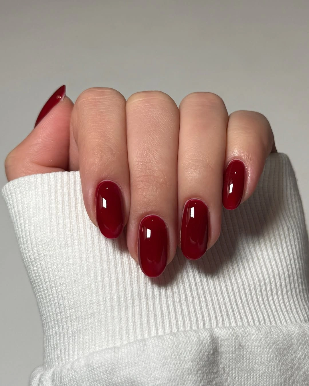 Deep wine short oval nails with glossy finish
