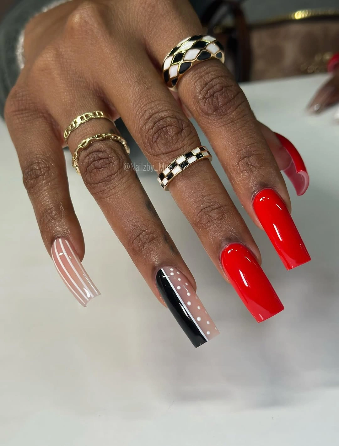 Red square nails with black and white graphic accents