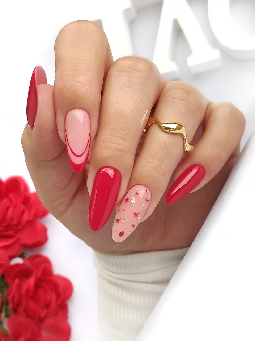 Red almond nails with floral nude accent