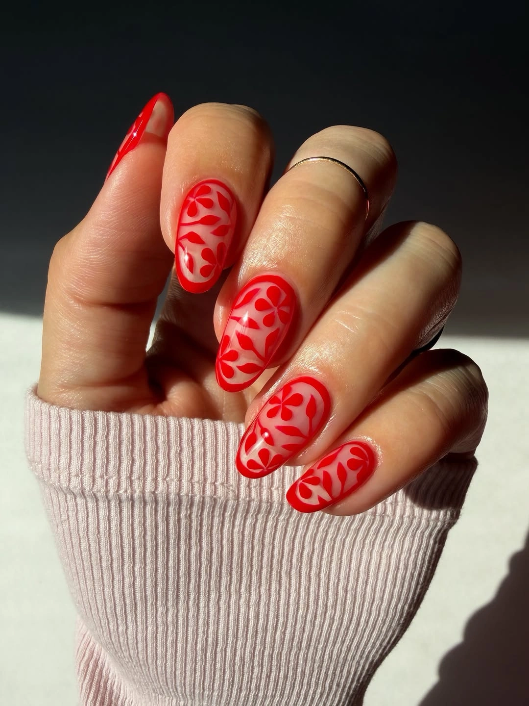 Sheer almond nails with red floral vine art