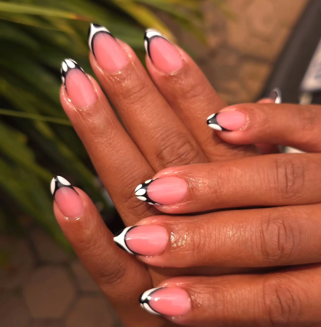 Peach almond nails with coral tips and dark outlined edges
