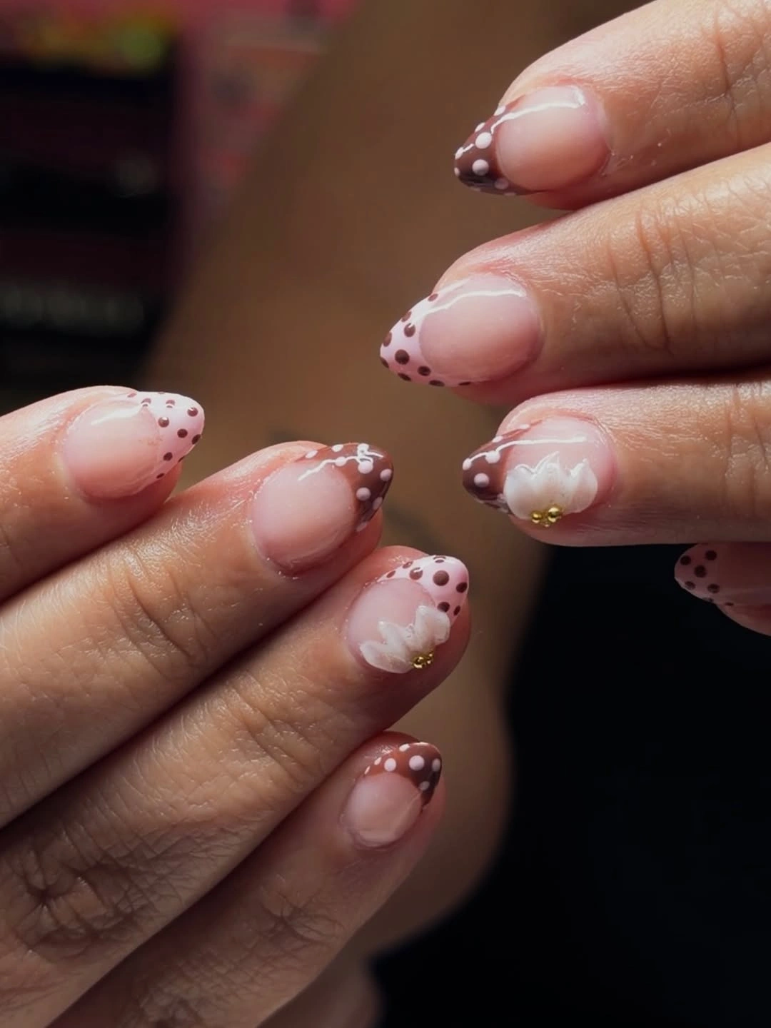 Blush short almond nails with pale tips and tiny berry flowers