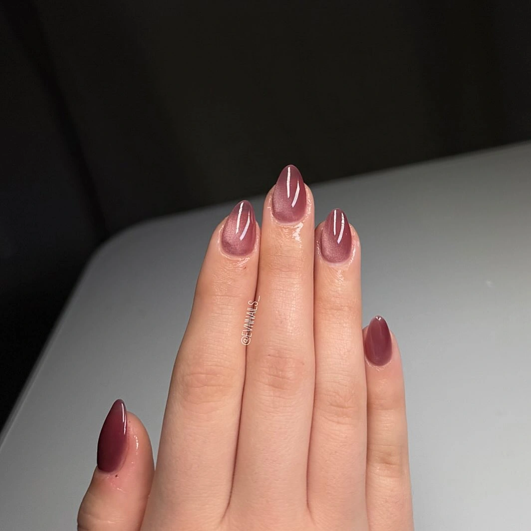 Sheer pink short almond nails with sparse burgundy accents