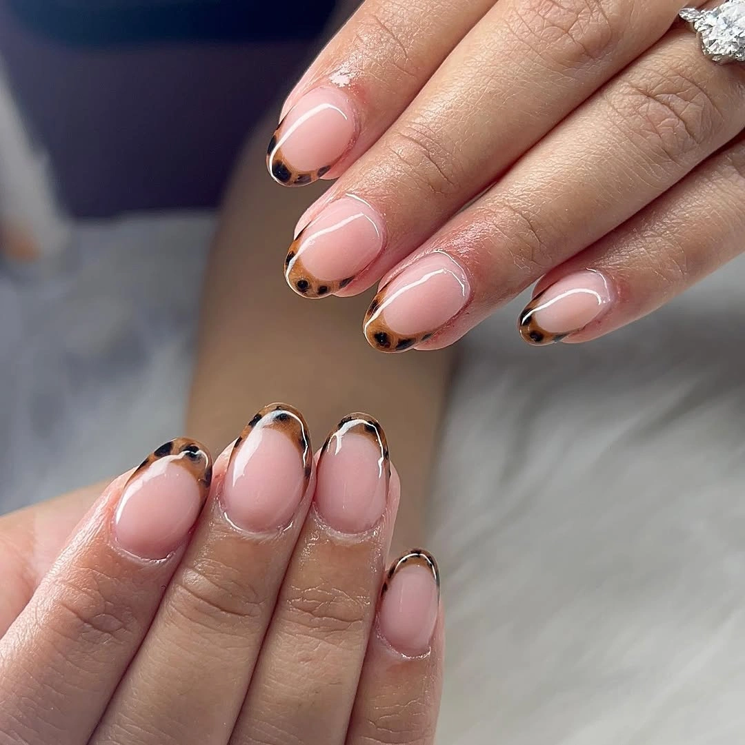 Short almond nails with layered dark and metallic French outlines