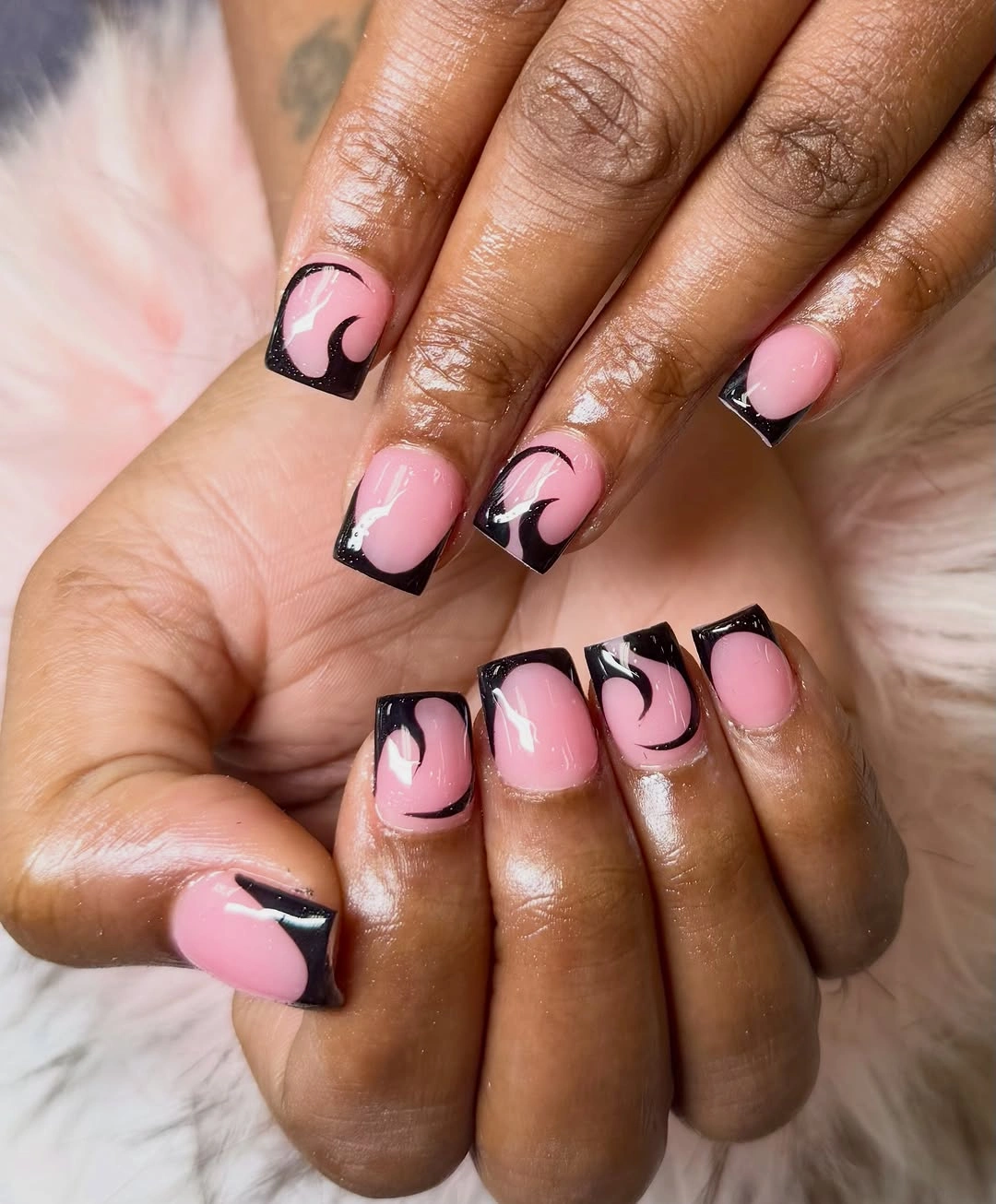 Short pink square nails with black curved corner French accents