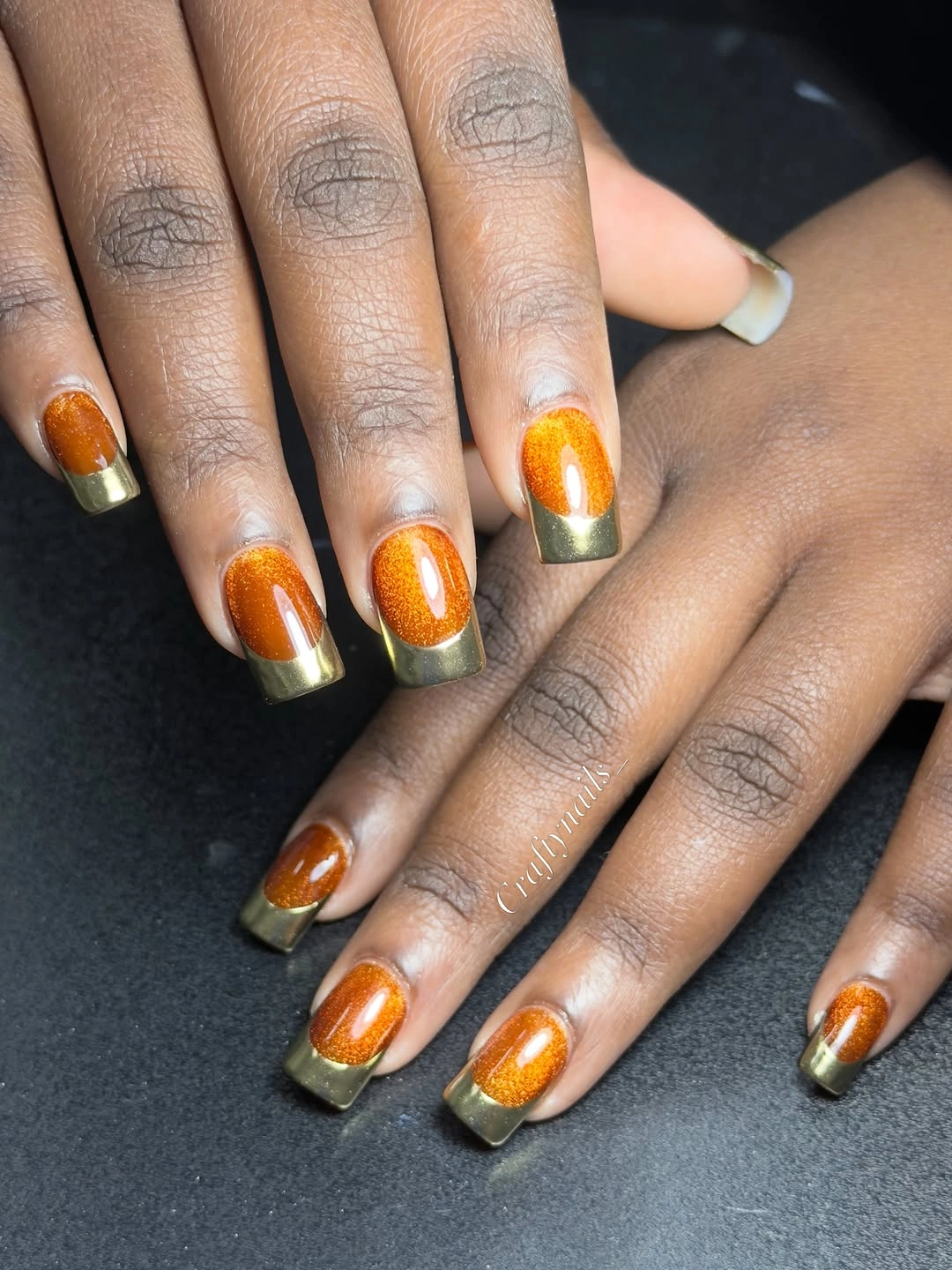 Short copper shimmer nails with deep olive brown tips