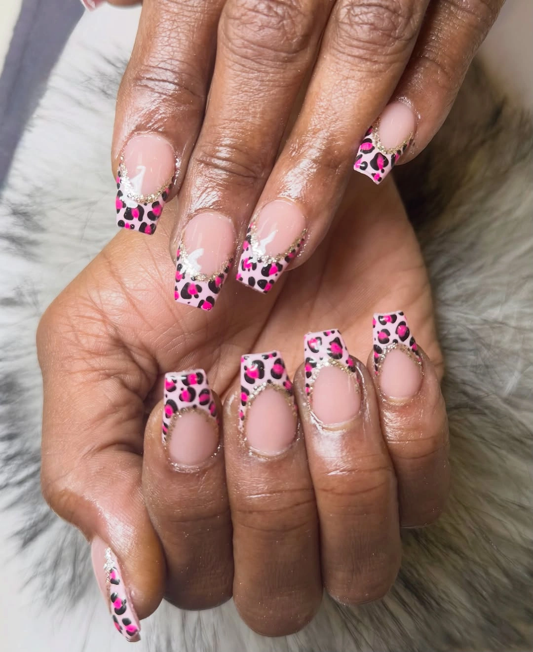 Short pink square nails with leopard patterned French tips