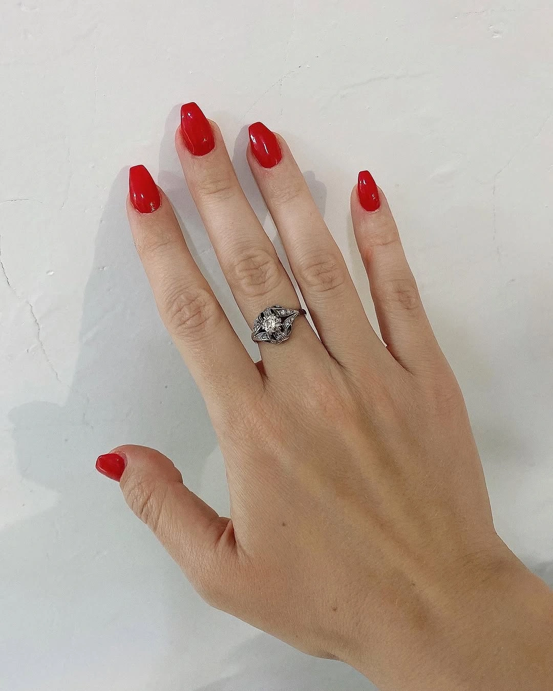 Short rounded red nails in a glossy solid finish