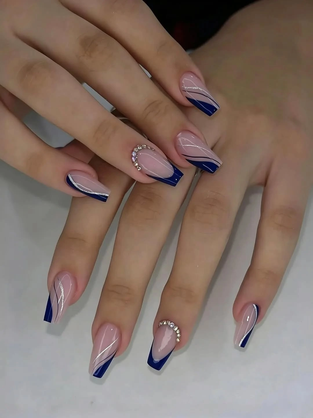 Pink coffin nails with navy angled French panels and white lines