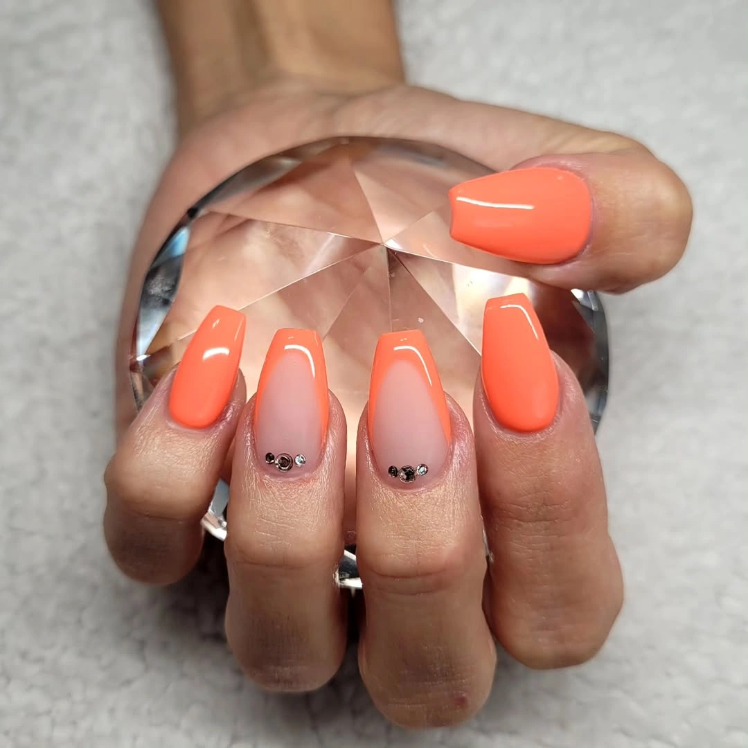Short coral square nails with tiny dark cuticle stones
