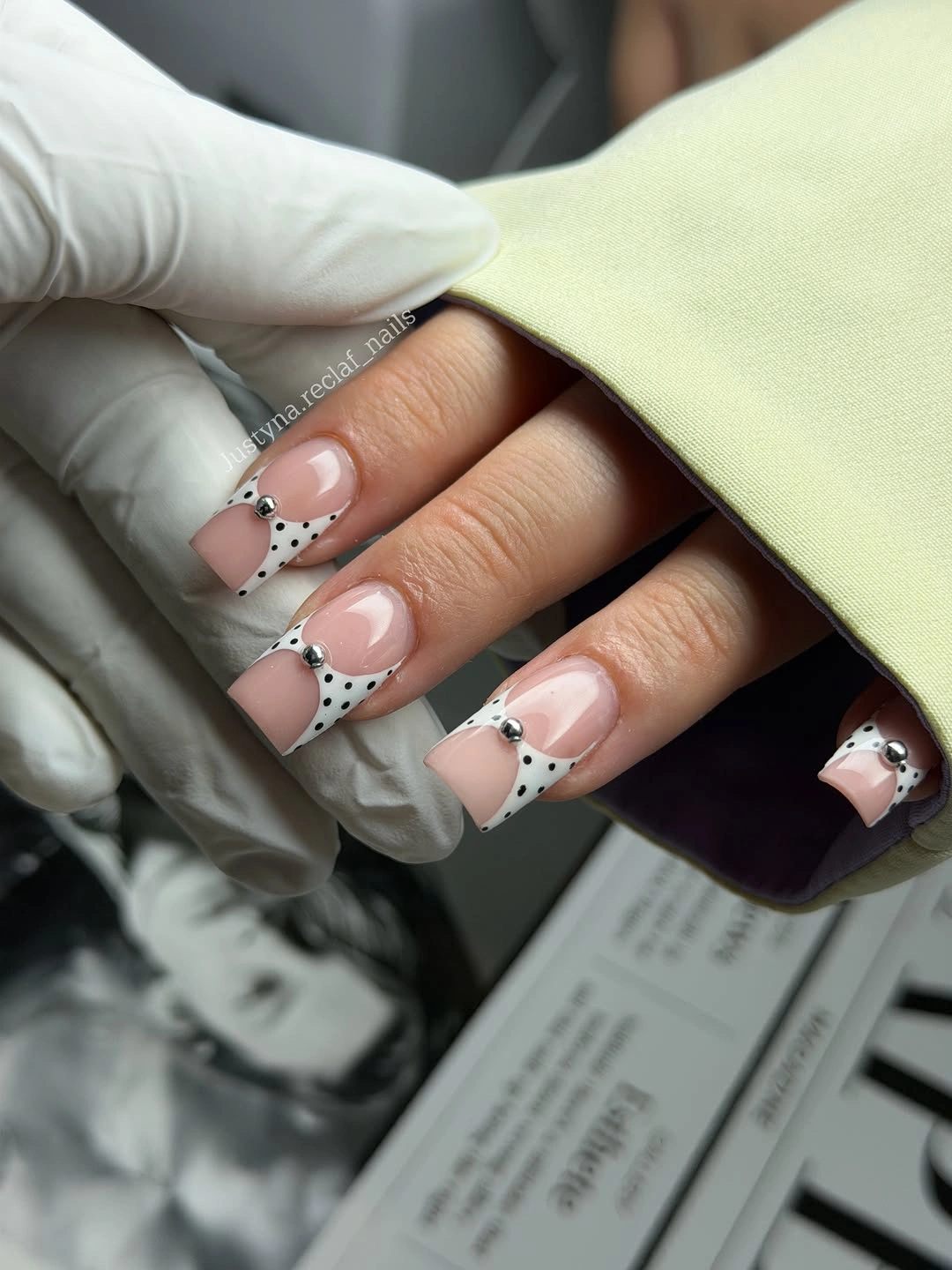 Short nude square nails with white tips black dots and fine dark curves