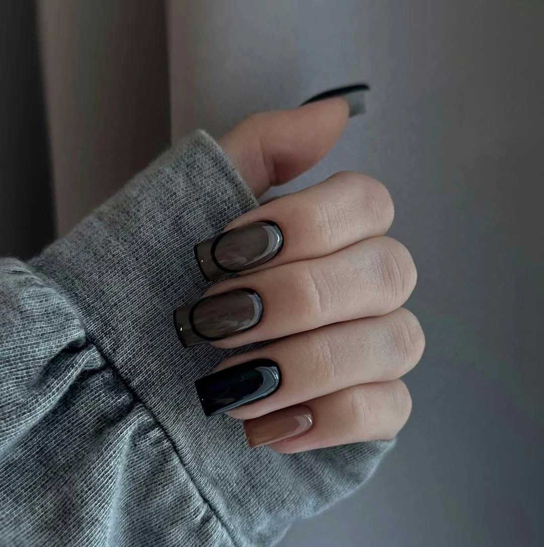 Medium nails in charcoal black taupe brown and pale neutrals with dark contour lines