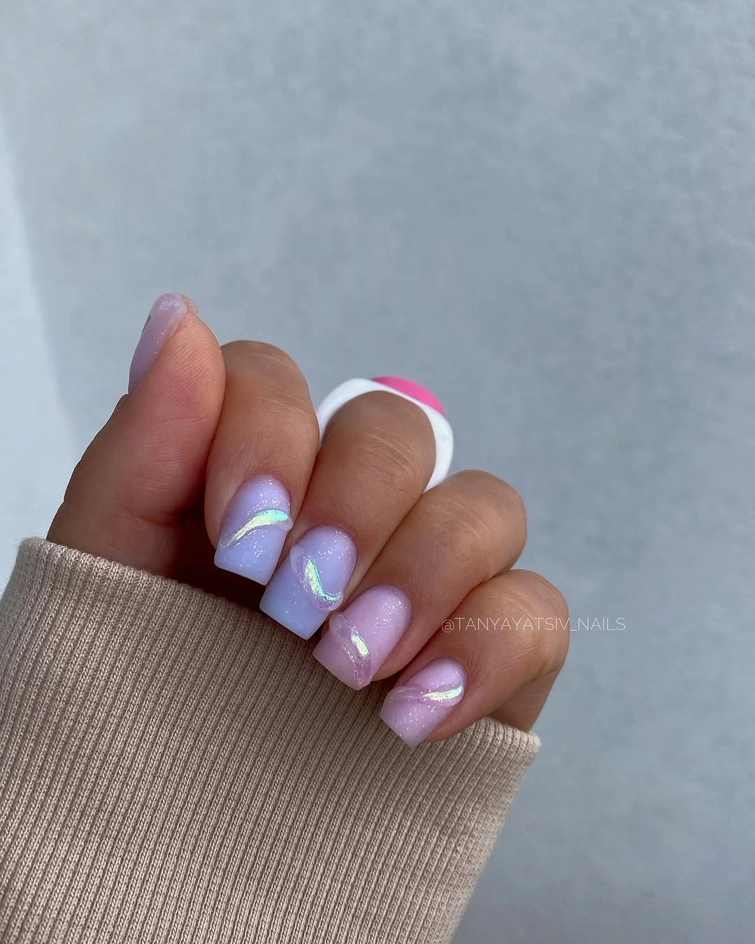 Short soft lilac square nails with curved white reflective-looking tips