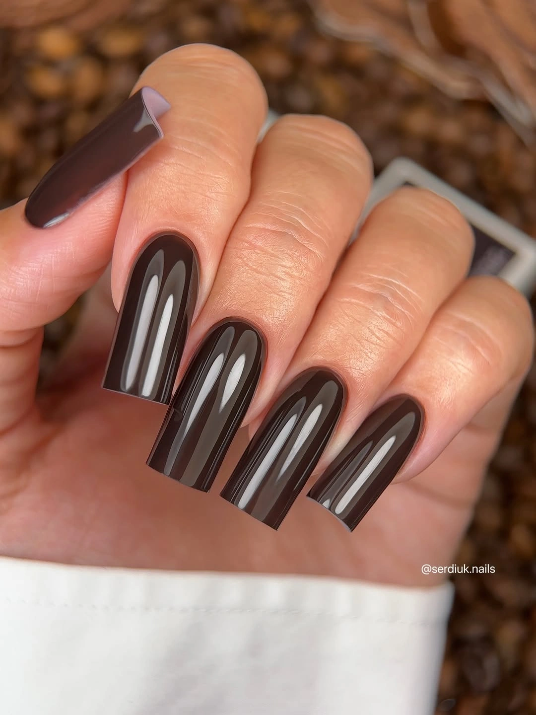 Long dark brown coffin nails with slim pale vertical and arched highlight lines