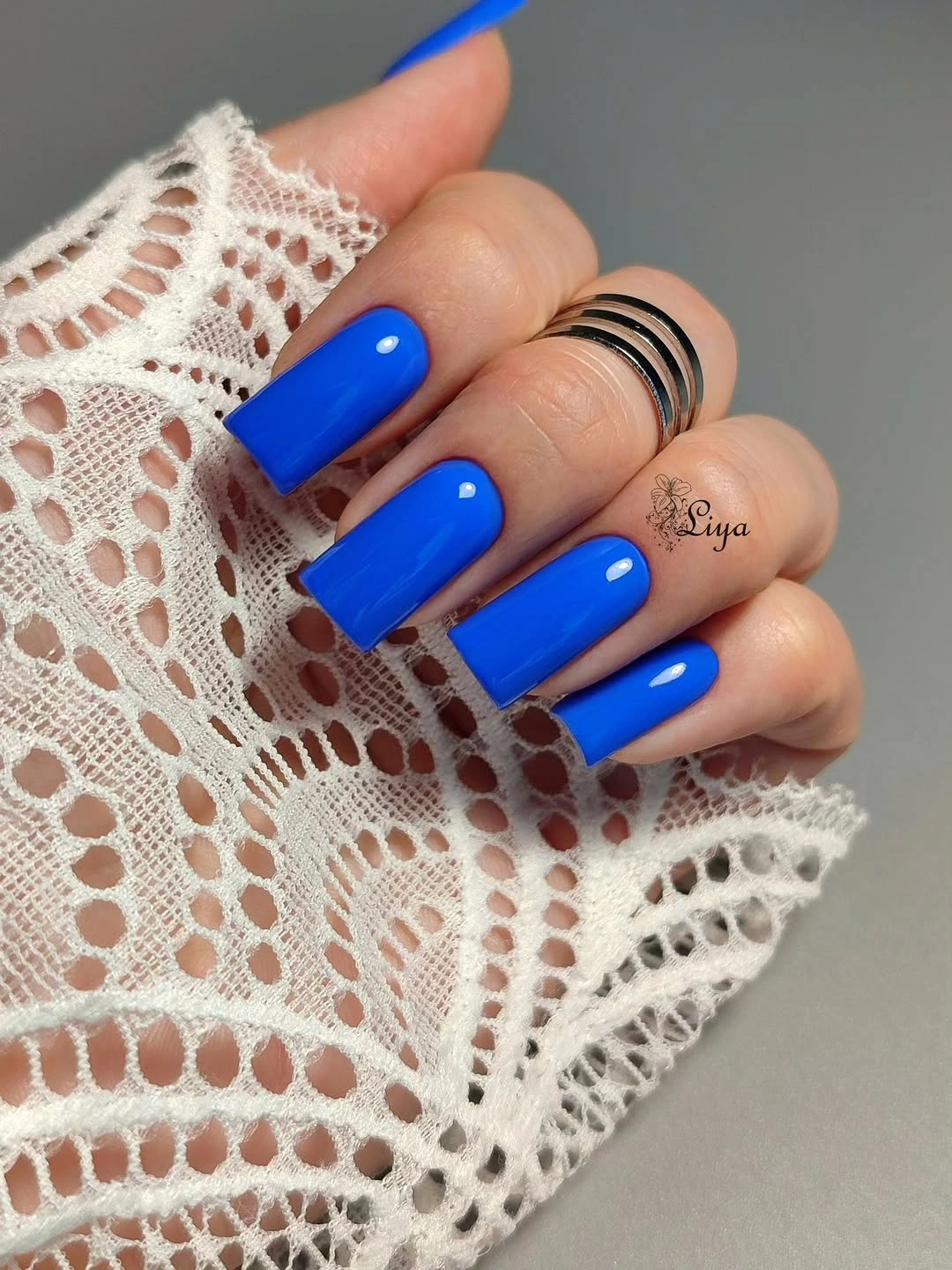 Long square nails in a vivid glossy cobalt blue solid color