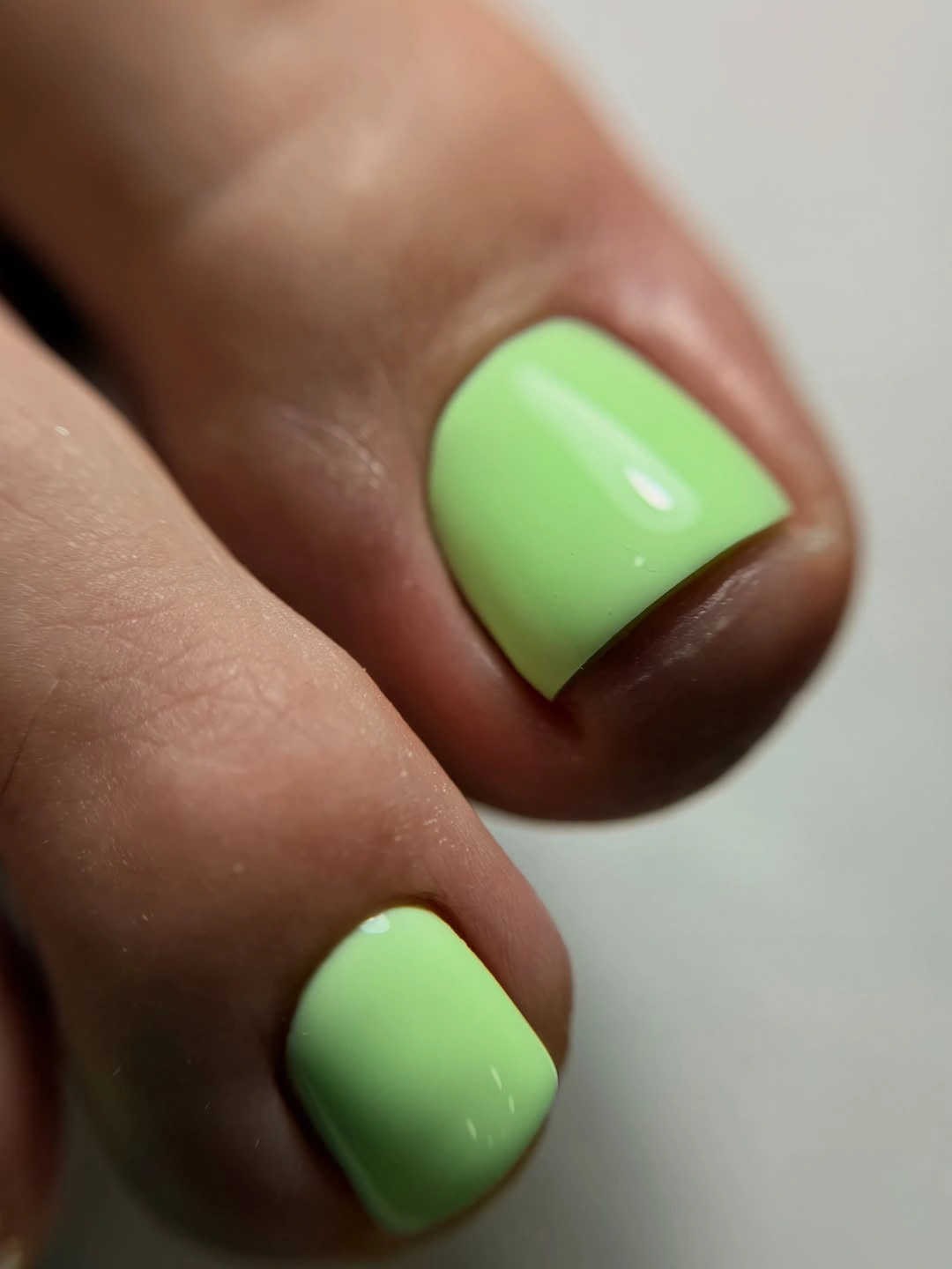 Bright mint green toes with smooth glossy coverage