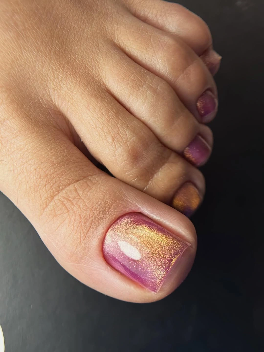 Iridescent plum gold big toe with berry color reflections