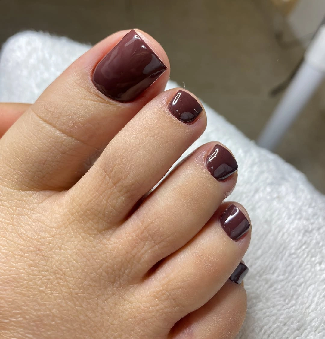 Glossy deep burgundy toes in a rounded square shape