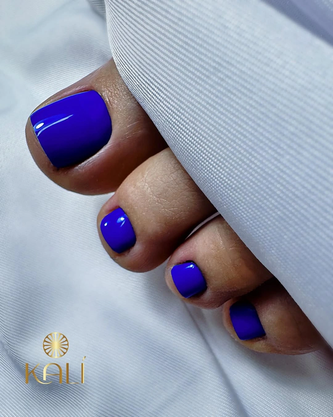 Glossy cobalt blue toes with compact rounded square edges